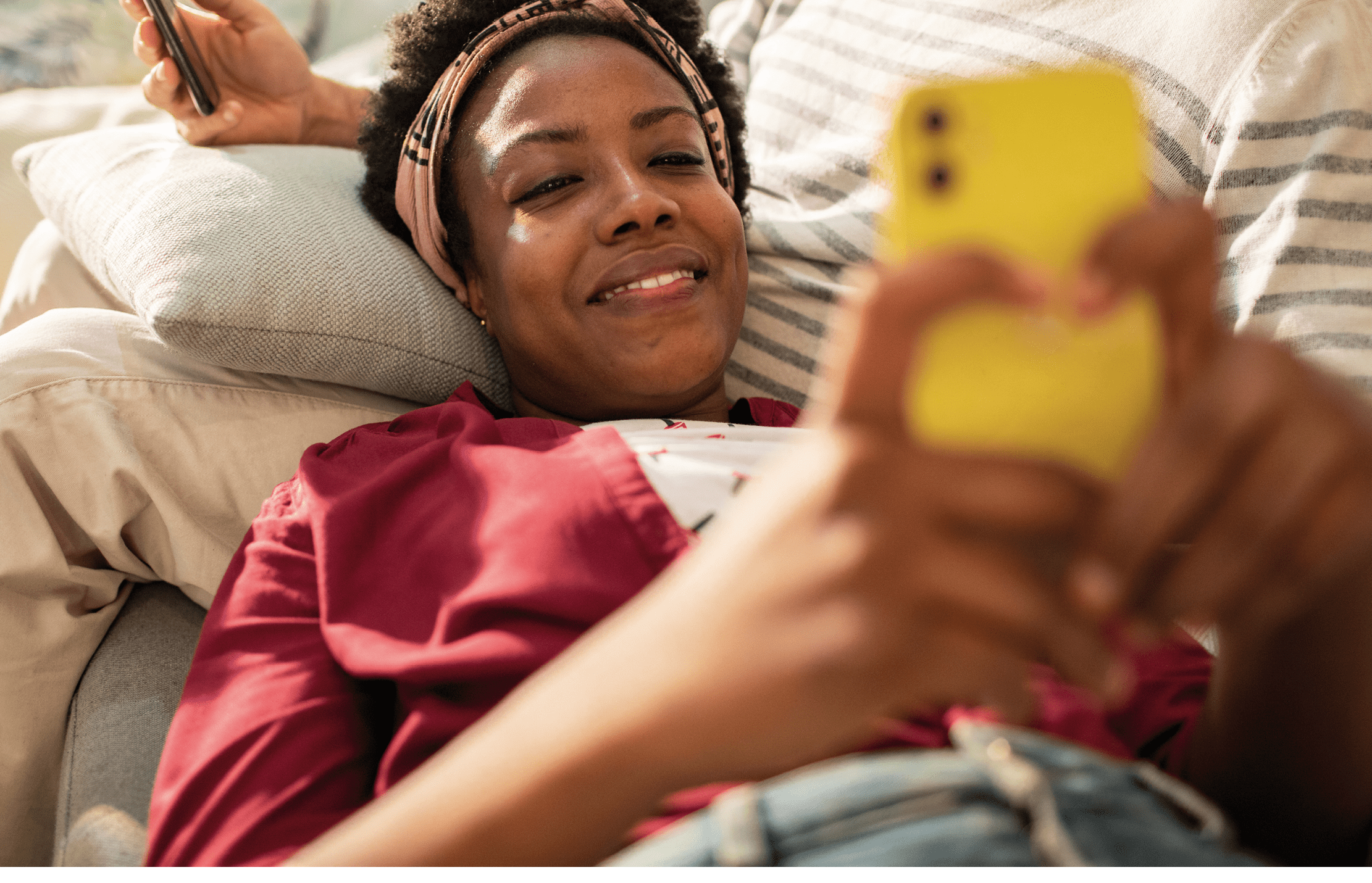 Close up of a Young couple using a phone on the couch at home