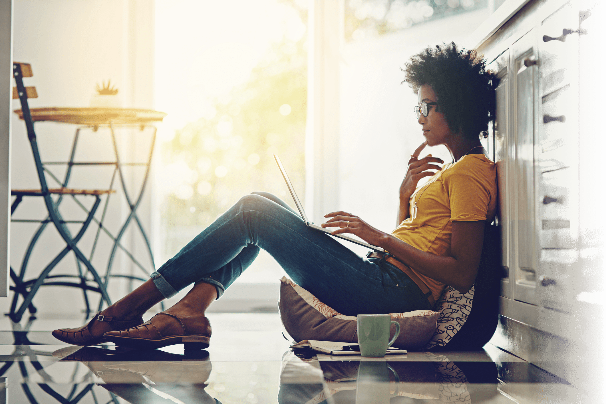 Full length shot of an attractive young woman using her laptop while chilling at home