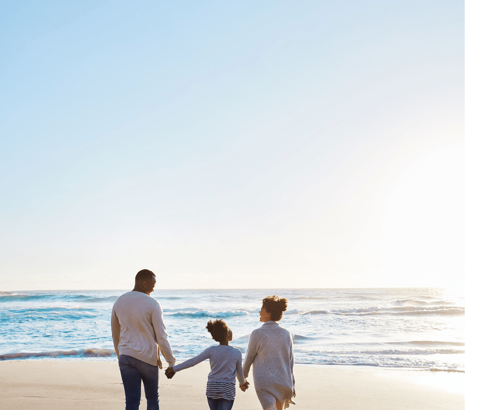 Shot of an adorable little girl going for a walk with her parents on the beach