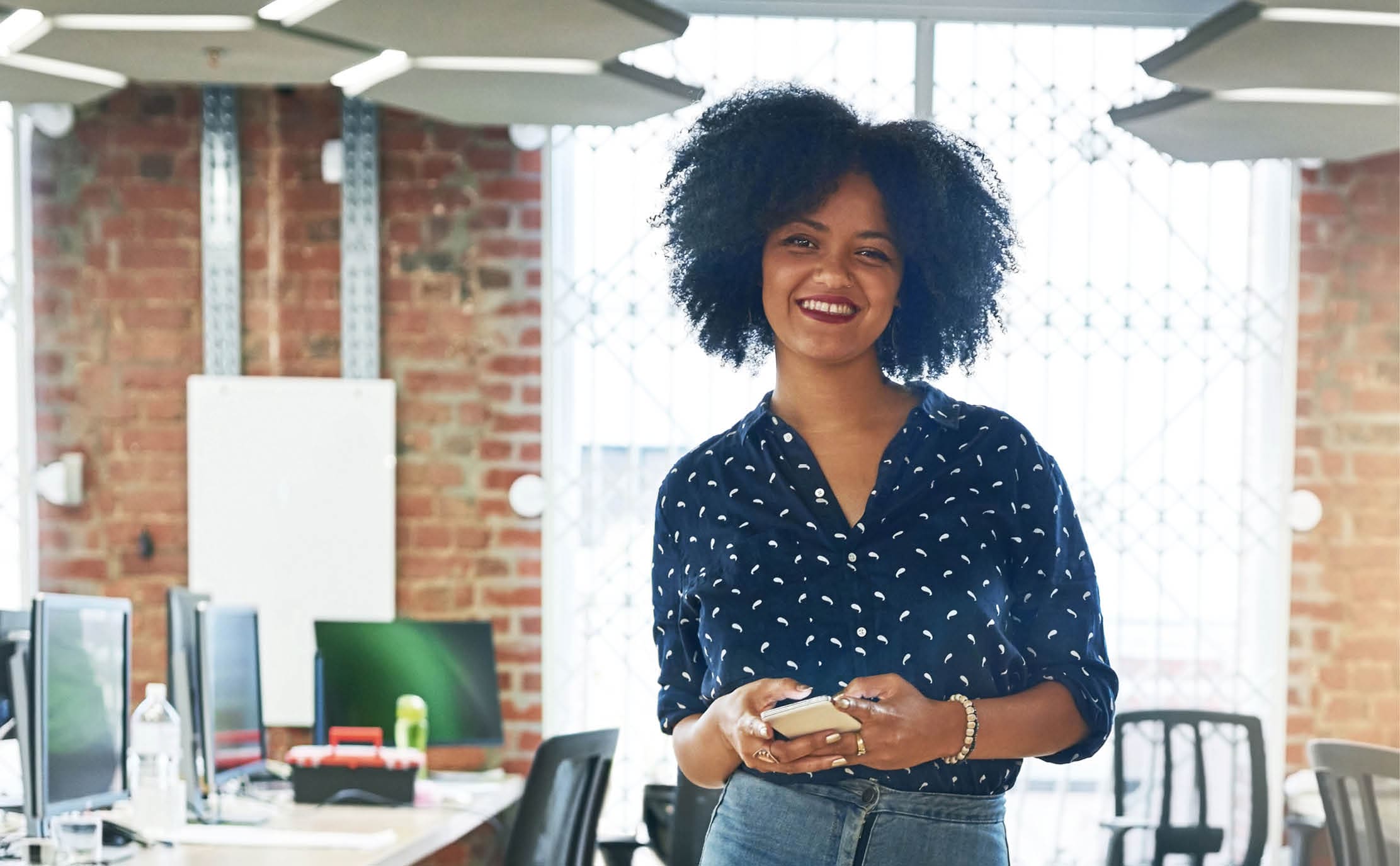 Shot of a young female designer working in her office